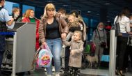 Ukrainian refugees who arrived in Germany with a first refugee plane from Moldova line up, after fleeing from Russia's invasion of Ukraine, at the international airport of Frankfurt, Germany, March 25, 2022. Boris Roessler/Pool via REUTERS/File Photo