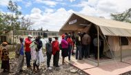 People stand in line to receive a COVID-19 vaccine, at the Narok County Referral Hospital, in Narok, Kenya, December 1, 2021. Picture taken December 1, 2021. REUTERS/Baz Ratner