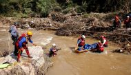 A search and rescue team prepares to airlift a body from the Mzinyathi River after heavy rains caused flooding near Durban, South Africa, April 19, 2022. REUTERS/Rogan Ward

