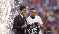 Paris St Germain's Kylian Mbappe poses for a photo with Paris St Germain president Nasser Al-Khelaifi after signing a new contract REUTERS/Christian Hartmann