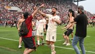 AC Milan's Olivier Giroud celebrates winning Serie A with AC Milan fans after the match REUTERS/Alberto Lingria
