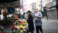 Kelly Wakeling assists a customer at her market stall ALK Fruit and Veg on Portobello Road, in London, Britain, May 30, 2022. REUTERS/Henry Nicholls


