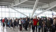 FILE PHOTO: Passengers queue to enter airport security ahead of the Easter Bank Holiday weekend, at Terminal 5 of Heathrow Airport, in London, Britain, April 14, 2022. REUTERS/Hannah McKay/File Photo
