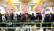 FILE PHOTO: Passengers wait for checking-in before boarding their flights to the U.S. at Madrid's Adolfo Suarez Barajas airport, Spain March 12, 2020. REUTERS/Sergio Perez/File Photo
