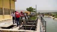 Qatar Red Crescent Society (QRCS)  officials at the work site.