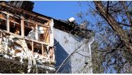 A firefighter works on the roof of a building after deadly rocket strikes at a residential area of Mykolaiv, amid Russia's attack on Ukraine, in this still image from undated handout video released June 17, 2022. State Emergency Service of Ukraine