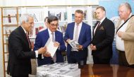 Minister of State, President of QNL H E Dr. Hamad bin Abdulaziz Al Kawari during the signing of the book.