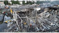 Rescuers work at a site of a shopping mall hit by a Russian missile strike in Kremenchuk, in Poltava region, Ukraine, in this handout picture released June 28, 2022. Press service of the State Emergency Service of Ukraine/Handout via Reuters 