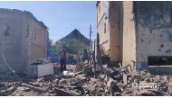 A man walks in the rubble near damaged buildings, as Russia's invasion of Ukraine continues, in Bakhmut, Donetsk Oblast, Ukraine in this still image obtained from a social media video released on July 2, 2022. National Police of Ukraine/Handout via REUTERS

