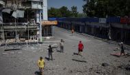 Local residents and journalists walk near a shopping center, destroyed by Russian military strike, amid Russia's invasion on Ukraine, in the town of Druzhkivka, in Donetsk region, Ukraine July 9, 2022. REUTERS/Gleb Garanich