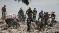 Rescuers work at a residential building damaged by a Russian military strike in the town of Chasiv Yar, in Donetsk region, Ukraine on July 10, 2022. (REUTERS/Gleb Garanich)