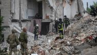 Rescuers work at a residential building damaged by a Russian military raid in the town of Chasiv Yar [Gleb Garanich/Reuters]