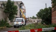 Rescuers work at a residential building damaged by a Russian military strike, amid Russia's invasion on Ukraine, in the town of Chasiv Yar, in Donetsk region, Ukraine, July 11, 2022. REUTERS/Gleb Garanich

