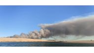 A general view shows smoke rising from the Gironde forest fires as seen from Dune de Pilat, Arcachon Bay, France July 12, 2022 in this picture obtained from social media. Quentin/via REUTERS


