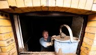 Walter Jueliger removes mud with a bucket from the cellar of a house after heavy rainfalls caused flooding of the nearby Erft river in Bad Muenstereifel, Germany July 17, 2021. REUTERS/Benjamin Westhoff