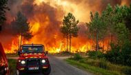 A view of trees burning amid a wildfire near Landiras, France, July 13, 2022 in this picture obtained from the fire brigade of the Gironde region (SDIS 33). SDIS 33/Handout via REUTERS