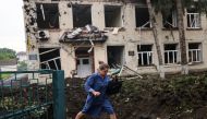 A teacher walks in front of a destroyed school following a military strike in Chuhuiv in Kharkiv region, Ukraine on July 16, 2022. (Reuters/Nacho Doce)