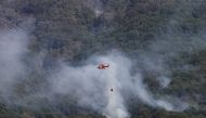 A helicopter works to contain a wildfire at Garganta de los Infiernos natural reserve, as the country experiences its second heatwave of the year, in Jerte, Spain, July 17, 2022. (REUTERS/Isabel Infantes)