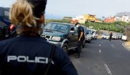File Photo: A female police officer stands guard on the Canary Island of La Palma, in La Laguna, Spain, September 21, 2021. (REUTERS/Borja Suarez)