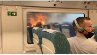Passengers look at the wildfire from train, near Zamora, Spain, on July 18, 2022, in this screen grab obtained from a social media video. (REUTERS/Francisco Seoane Perez)

