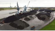 An aerial view shows coal at a dry bulk terminal of German Rheinberg-Orsoy harbor along Europe’s most important shipping way Rhine in Rheinberg near Duisburg, Germany, April 6, 2022. Picture taken with a drone. REUTERS/Stephane Nitschke