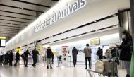 Travellers stand at Terminal 2 of Heathrow Airport, amid the coronavirus disease (COVID-19) outbreak in London, Britain February 14, 2021. REUTERS/Henry Nicholls/File Photo