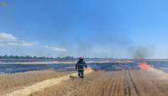 A firefighter works in a field, which burns after a military strike, as Russia's attack on Ukraine continues, in Mykolaiv region, Ukraine, in this handout picture released July 27, 2022. Press service of the State Emergency Service of Ukraine/Handout via REUTERS ATTENTION EDITORS - THIS IMAGE HAS BEEN SUPPLIED BY A THIRD PARTY.