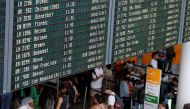 A view of departure boards displaying cancelled flights as passengers wait at Munich Airport during a warning strike staged by Lufthansa ground staff over 9.5 % pay claim by Germany's public sector workers union Verdi in Munich, Germany July 27, 2022. REUTERS/Michaela Rehle