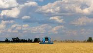 A combine harvests wheat during Ukraine-Russia conflict in the Russia-controlled village of Muzykivka in the Kherson region, Ukraine July 26, 2022. REUTERS/Alexander Ermochenko

