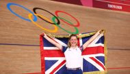 Gold medallist Laura Kenny of Britain poses with the Union Jack at the last day of the cycling track events. REUTERS/Matthew Childs

