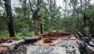 A Ukrainian serviceman stands atop a destroyed tank, in this handout picture released August 1, 2022. (Reuters)