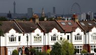 A person jogs past a row of residential housing in south London, Britain, August 6, 2021. REUTERS/Henry Nicholls

L