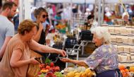 A woman shops at Campo de' Fiori market, on the day the European Central Bank's rate-setting Governing Council holds an unscheduled meeting to discuss the recent sell-off in government bond market, in Rome, Italy, June 15, 2022. REUTERS/Guglielmo Mangiapane