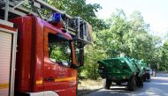 Firefighter vehicles are seen near the closed motorway access Huettenweg, due to an explosion in munitions depot in the Grunewald forest in Berlin, Germany August 4, 2022. REUTERS/Annegret Hilse