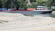 A container vessel passes the Loreley Rock at low water levels as recent dry weather continues, that prevented cargo vessels from sailing fully loaded on the river Rhine, in Sankt Goar, Germany, July 19, 2022. REUTERS/Wolfgang Rattay/File Photo