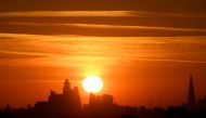 The sun rises behind the London skyline as a second heatwave is predicted for parts of the country, Richmond Park, London, Britain, August 8, 2022. REUTERS/Toby Melville