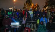 People use a projector to follow the counting of the casted votes in the general election in Kibera slums of Nairobi, Kenya August 10, 2022. Reuters/Thomas Mukoya