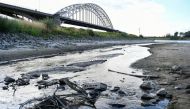 A view of bicycles that reemerged due to the low water level in a side channel of the Waal River in Nijmegen, Netherlands August 8, 2022. REUTERS/Piroschka van de Wouw