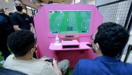 Fans enjoying a football game at Mall of Qatar yesterday as part of the 100-day countdown to FIFA World Cup Qatar 2022. Pic: Rajan Vadakkemuriyil / The Peninsula