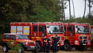 Romanian firefighters arrive at a wildfire command post in Hostens to assist French firefighters, as wildfires continue to spread in the Gironde region of southwestern France, August 12, 2022. REUTERS/Stephane Mahe