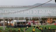 Staff members clean the venue of Medusa Festival, an electronic music festival, after high winds caused part of a stage to collapse, in Cullera, near Valencia, Spain, August 13, 2022. Reuters/Eva Manez