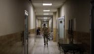 A soldier, who assists at the emergency ward, makes his way in the corridor of a military hospital, as Russia's attack on Ukraine continues, in Donetsk region, Ukraine, August 9, 2022. REUTERS/Alkis Konstantinidis