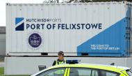 A police officer stands on duty outside an entrance at UK's biggest container port Felixstowe, as workers begin an 8-day strike, in Felixstowe, Britain, August 21, 2022. REUTERS/Toby Melville