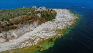 Underwater rocks emerge from the water of Lake Garda after northern Italy experienced the worst drought in 70 years in Sirmione, Italy, August 16, 2022. REUTERS/Flavio Lo Scalzo/Files

