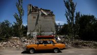 62-year-old Ukrainian Arkadii drives a car after leaving his destroyed house, as Russia's attack on Ukraine continues, in Toretsk, Donetsk region, Ukraine August 22, 2022. REUTERS/Ammar Awad