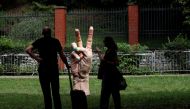 People look at a statue of a hand with finger nails painted in colors of Ukraine's national flag marking the Independence Day of Ukraine in front of the Russian embassy, in Prague, Czech Republic, on August 24, 2022. REUTERS/David W Cerny