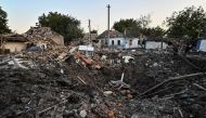 People stand next to a residential house destroyed by a Russian military strike, as Russia's attack on Ukraine continues, in Chaplyne, Dnipropetrovsk region, Ukraine, on  August 24, 2022. REUTERS/Dmytro Smolienko