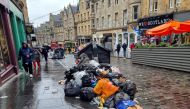Waste is overflowing from bins on a street amid a strike by waste services workers in Edinburgh, Scotland, Britain, August 26, 2022. (REUTERS/Andy Bruce)
