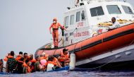 Members of Italian Guardia Costiera prepare to bring on board the migrants of a wooden boat near the island of Lampedusa, in the Mediterranean Sea, on September 1, 2021. File Photo / REUTERS/Juan Medina