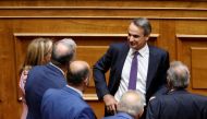 File Photo: Greek Prime Minister Kyriakos Mitsotakis speaks with members of his government and lawmakers during a parliamentary session on a wiretapping case, in Athens, Greece, August 26, 2022. (REUTERS/Costas Baltas)